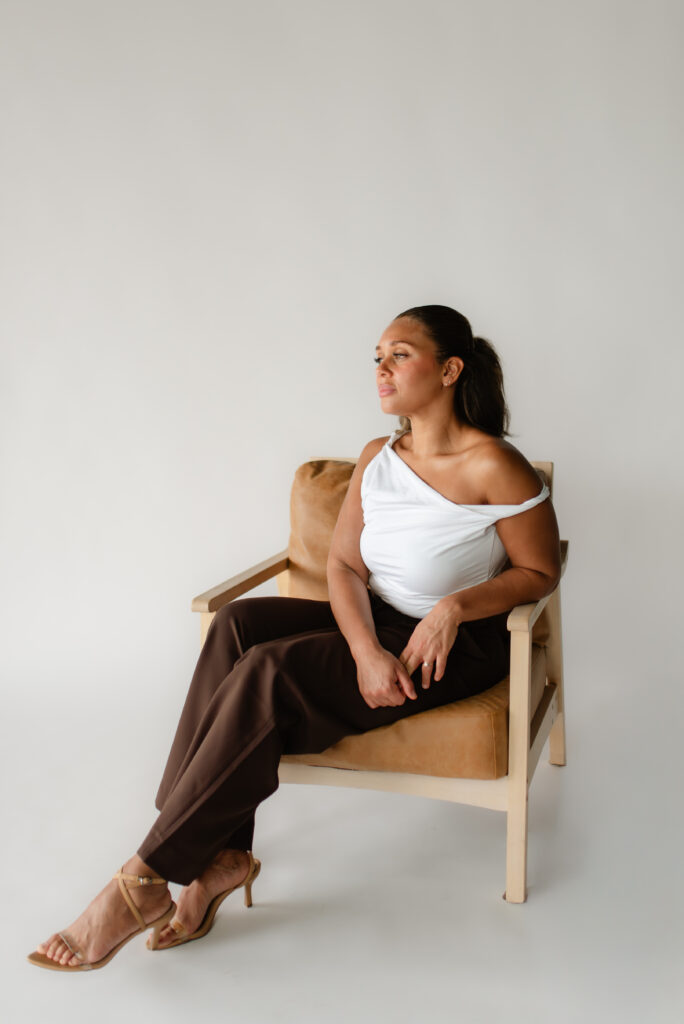 Full-body studio portrait of woman seated in a chair for Aesthetics branding