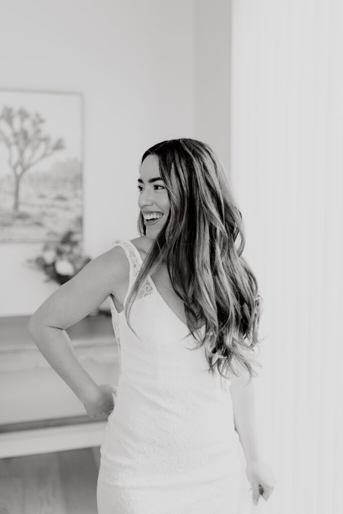 Black and white portrait of bride laughing indoors before elopement