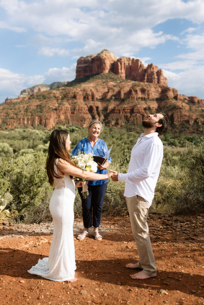 Bride and groom holding hands during intimate Sedona elopement ceremony