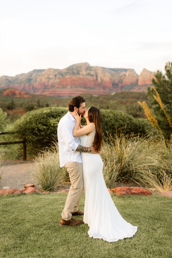 Couple kissing with Sedona red rock mountains in the background