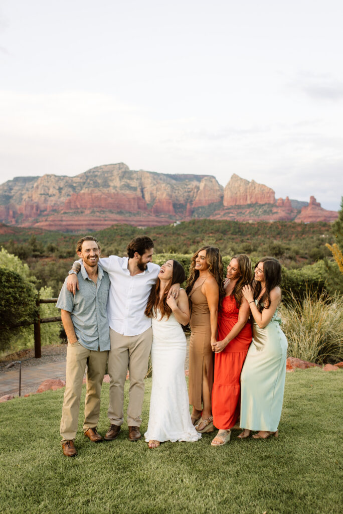 Wedding party laughing together with Sedona red rock view behind them