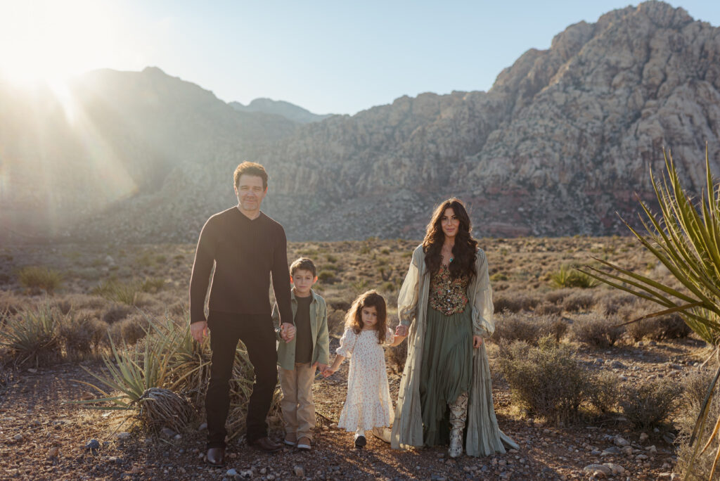 Family walking together in the desert at golden hour near Red Rock Canyon, Las Vegas.