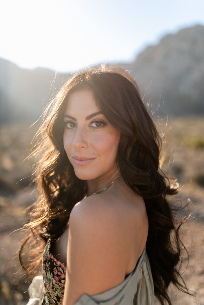 Backlit portrait of woman with sun flare during a Red Rock Canyon session in Las Vegas.