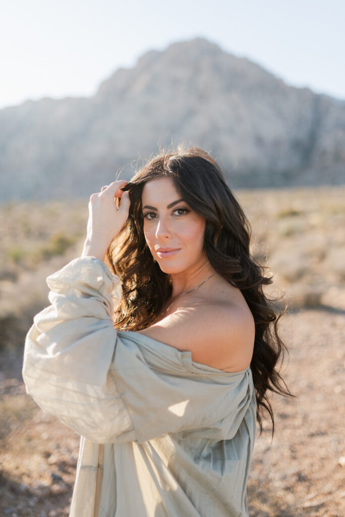 Close up portrait of woman in soft desert light with mountains behind her near Las Vegas.