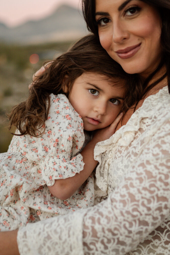 Mother hugging her child during an outdoor family session near Red Rock Canyon.
